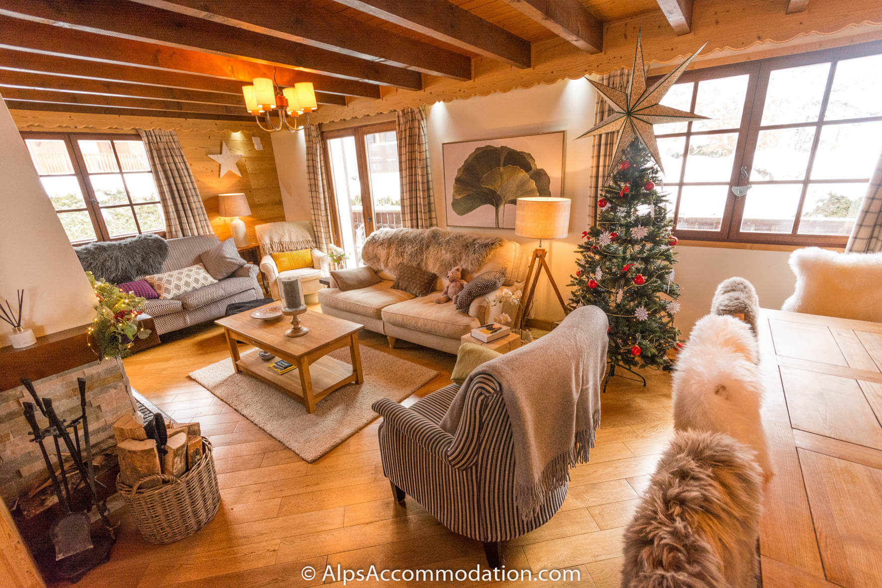 Chalet Étoile Morillon - Comfortable living area with log fire and sunny balcony beyond