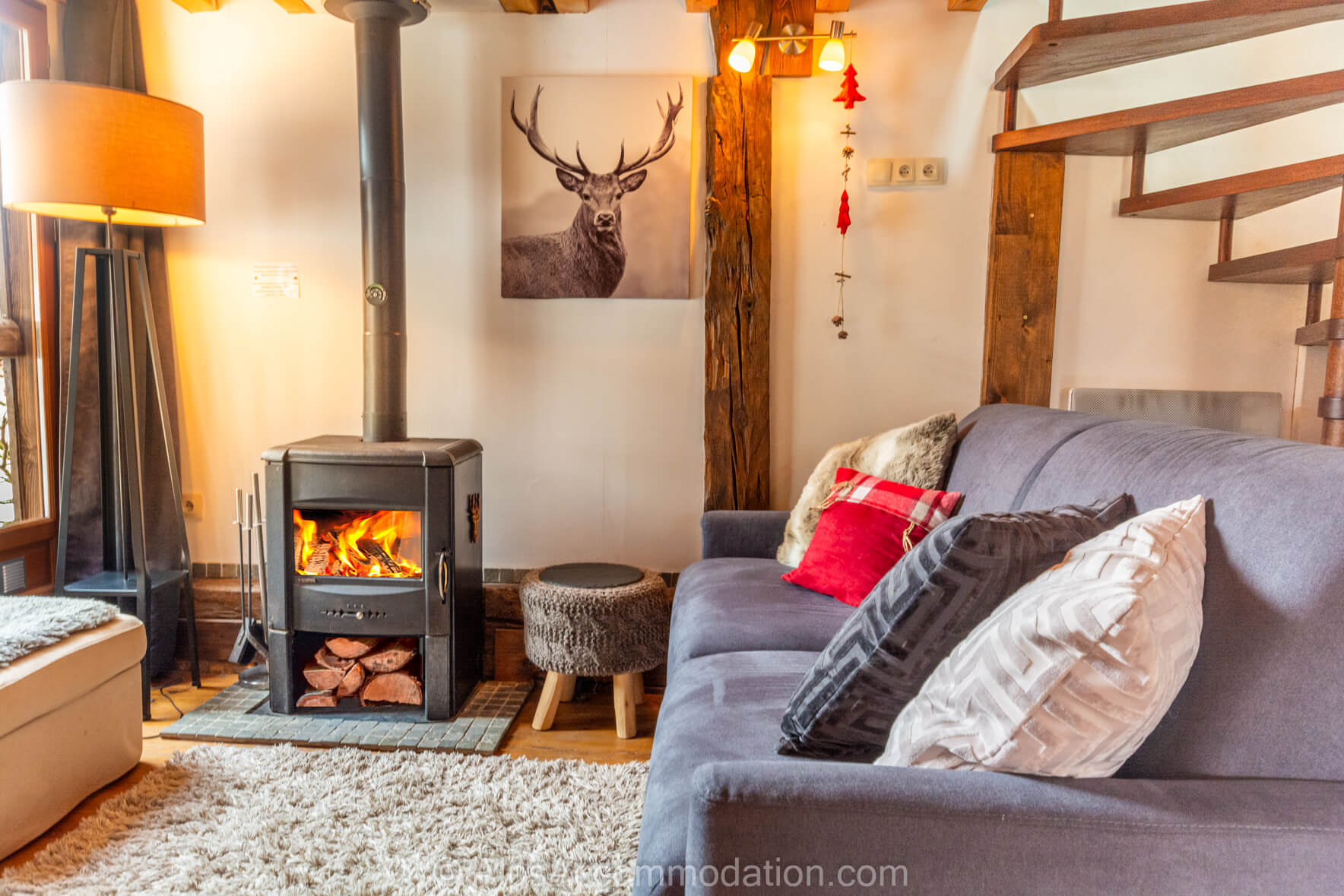 The Mazot Samoëns - Cosy living area with comfortable sofa and log burner