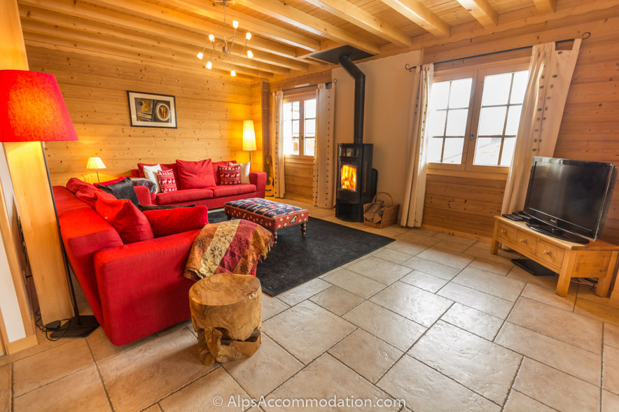 Chalet Kassy Morillon - Spacious living area with huge comfortable sofas and a cosy log burner