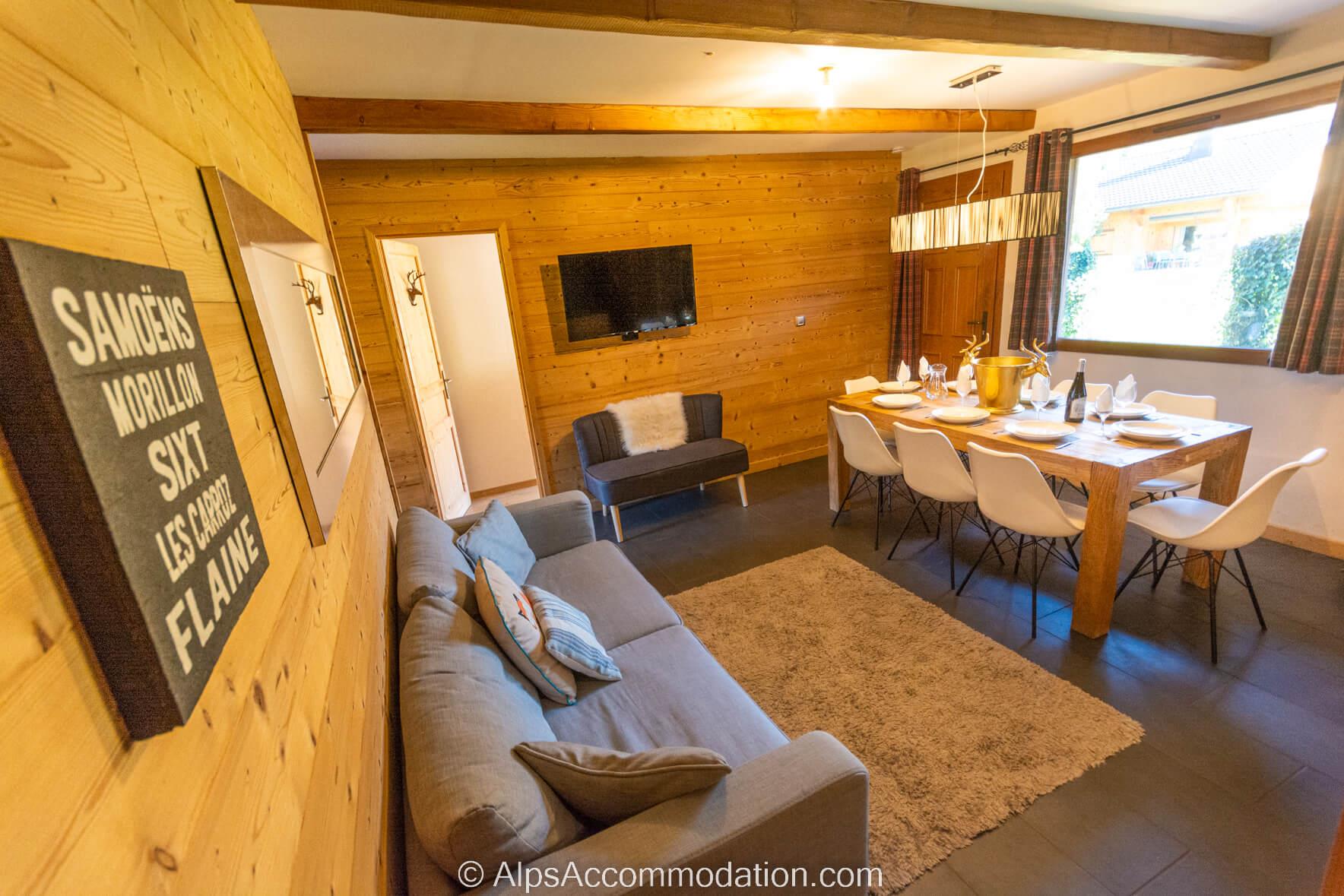 Chalet Balthazar Samoëns - Dining area and living area with views over the garden and a cosy log burner