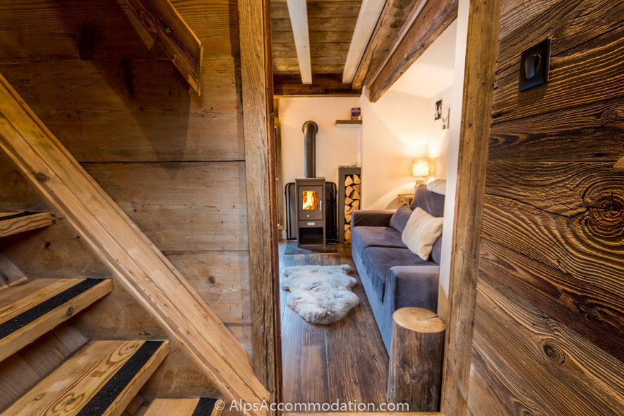 La Cabine Samoëns - The view from the staircase to the living area with cosy log fire